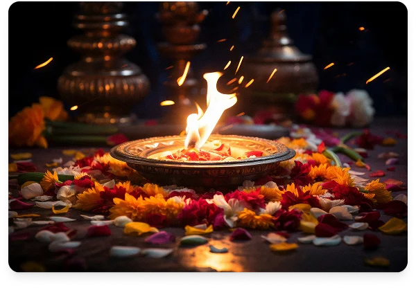 Traditional diya lamp surrounded by flowers representing spiritual guidance and answers to frequently asked questions at Vishnumaya Spirit