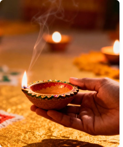 Hand holding a traditional diya lamp representing trusted spiritual guidance of Vishnumaya and Kuttichathan and devotional practices at Vishnumaya Spirit